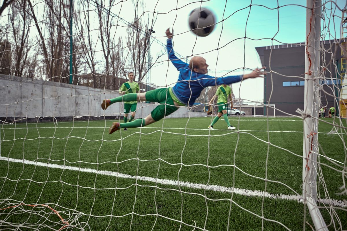 World cup soccer football goalkeeper making diving save at goal post